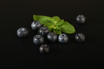 still life of fresh fruits and herbs on a dark background close up