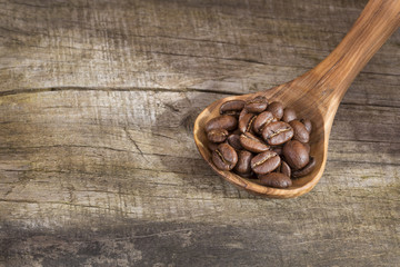 Roasted coffee on the wooden background - Coffea