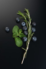 still life of fresh fruits and herbs on a dark background close up