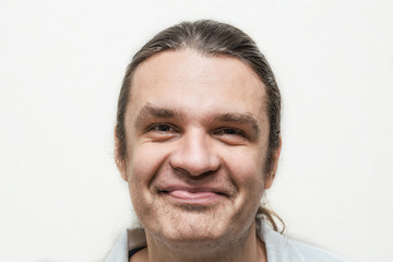 Obraz premium Funny smiling man looking at camera on white background