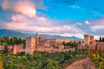 Fototapeta na wymiar Palace and fortress complex Alhambra with Comares Tower, Palacios Nazaries and Palace of Charles V during sunset in Granada, Andalusia, Spain