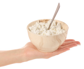 Bowl of cottage cheese with spoon in hand