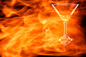 Empty Martini glass in the fire flames.