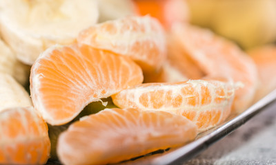 Organic peeled mandarins on a plate.Close up shoot