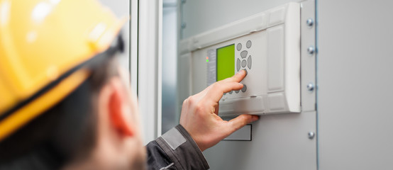 Close up of maintenance engineer testing voltage switchgear