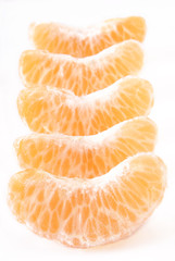 Slices of peeled orange on white background      