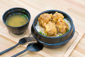 Japanese cuisine - Fried Pork with egg on rice. 
Katsudon - Japanese breaded deep fried pork cutlet on wooden table.