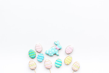 Fototapeta na wymiar Easter background. Cookies in shape of easter bunny and easter eggs. White background top view space for text