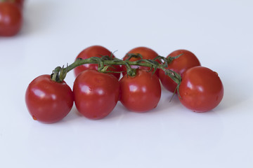 Beautiful tiny red organic tomatoes on the table. Close-up shot.