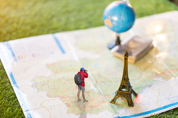Women traveler Is planning a tour her standing on the world map.She is take a photo.
