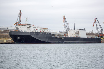 Fototapeta premium RORO ship in port at on ferry. ferryboat terminal on loading, unloading.