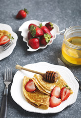 Crepes with berries and honey
