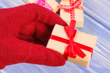 Hand of woman in gloves with gifts for Valentines Day