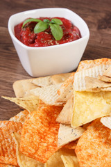 Salted potato crisps, cookies and sauce, concept of unhealthy food