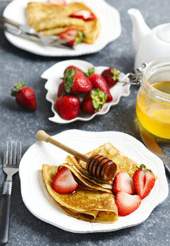 Crepes with berries and honey