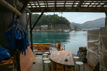 Restaurant in .Ine Boathouse is traditional Fisherman Village on a rainy day of Kyoto, JAPAN.