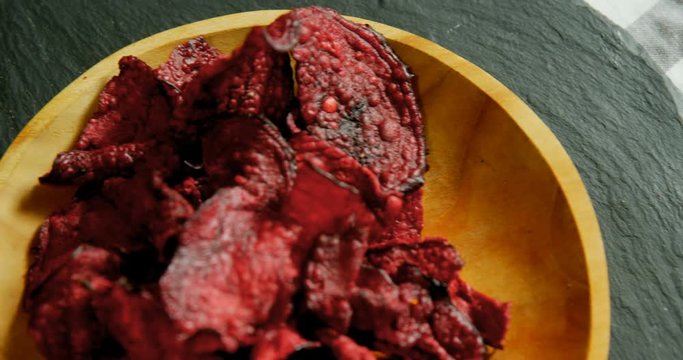 Dried beetroot in plate placed on wooden surface  