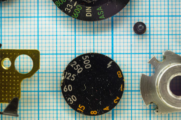 parts old retro film SLR camera on graph paper