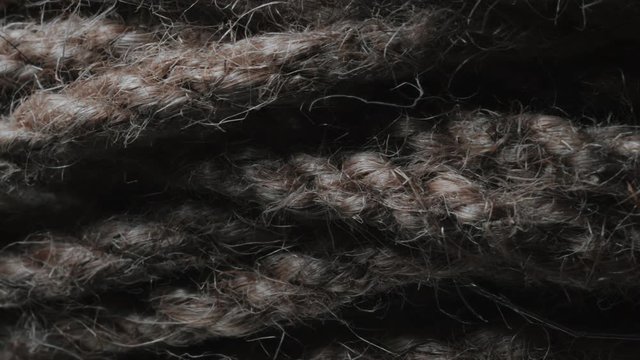 Ball of string extreme close up. String in macro with rotating camera move. Natural Brown Jute Burlap Rustic Twine String Rope Cord Decor. Lots of fibers and weaves. 4k