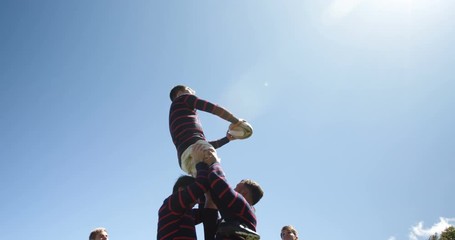 Rugby players practicing to defend the ball  
