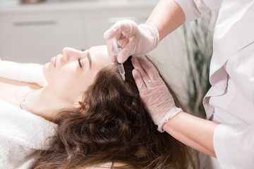 Obraz na płótnie Canvas The concept of mesotherapy. Thrust to strengthen the hair and their growth