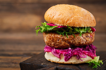 Sandwich hamburger with juicy burgers,  red cabbage and pink sauce