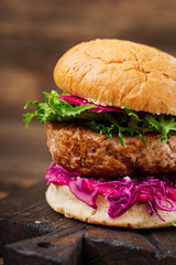 Sandwich hamburger with juicy burgers,  red cabbage and pink sauce