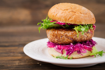 Sandwich hamburger with juicy burgers,  red cabbage and pink sauce