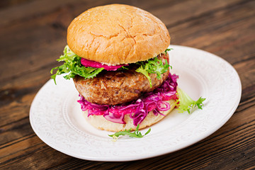 Sandwich hamburger with juicy burgers,  red cabbage and pink sauce