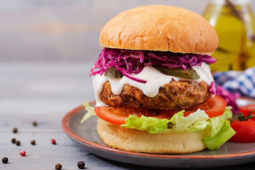 Sandwich hamburger with juicy burgers, tomato and red cabbage