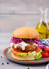 Sandwich hamburger with juicy burgers, tomato and red cabbage
