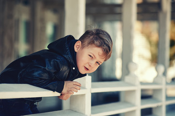 Curious boy in town , looks leaning on the railing © fisher05
