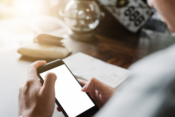 Close up of man using mobile smart phone,sending massages on the garden.having sunbath.Phone with black screen,texting,video calls,