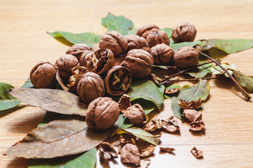 Several walnuts lie on brown background