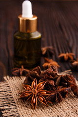 essential oil of the anise stars on a dark rustic background