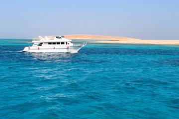 White Yacht sails by the sea