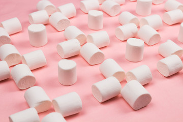 Marshmallows on pink pastel background.