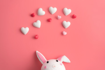 Valentines heart and rabbit on a pink color background.Happy Valentines Day background. Can be used for celebrations valentines day.