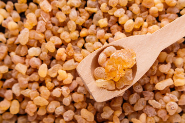 frankincense essential oil on a wooden background