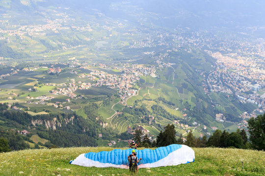 Paragliders start Paragliding in front of Merano panaroma in South Tyrol