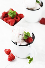 Sweet summer ice cream with raspberry on the white stone background