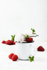 Sweet summer ice cream with raspberry on the white stone background