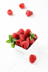 Sweet fresh raspberry on the white stone background