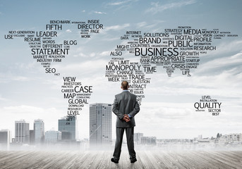 Motivation and inspiration concept with modern cityscape and businessman observing it