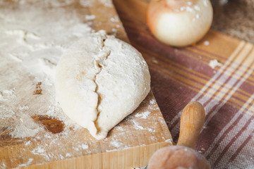 Roasted patty lay on board with flour