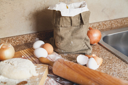 bag eggs and rolling pin lying on kitchen table
