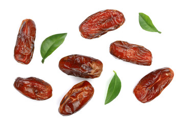 dry dates with green leaves isolated on white background. Top view. Flat lay pattern