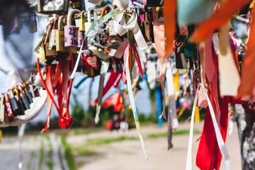 Many multi-colored ribbons and locks are hanging on tree