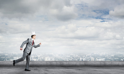 King businessman in elegant suit running on building roof and business center at background