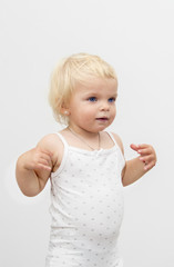 portrait of little baby girl with blond hair on white background